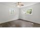 Bright bedroom featuring hardwood floors, neutral walls, a ceiling fan, and two windows allowing ample natural light at 1314 Hudson Ave, Durham, NC 27705