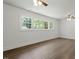 Bright bedroom featuring hardwood floors, neutral paint and a large window at 1314 Hudson Ave, Durham, NC 27705
