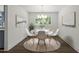 Bright and airy dining room featuring modern decor, a view of the backyard, and hardwood floors at 1314 Hudson Ave, Durham, NC 27705