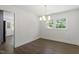 Cozy dining room featuring hardwood floors, a modern chandelier, and large windows at 1314 Hudson Ave, Durham, NC 27705
