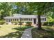 Charming single-story home with manicured lawn, lush shrubbery, and welcoming walkway to front door at 1314 Hudson Ave, Durham, NC 27705