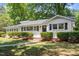 Charming single-story home with a well-kept lawn, manicured bushes, and classic black shutters at 1314 Hudson Ave, Durham, NC 27705