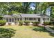 Charming single-story home with a well-kept lawn, manicured bushes, and classic black shutters at 1314 Hudson Ave, Durham, NC 27705