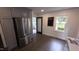 Kitchen area boasts stainless steel appliances, dark hardwood floors, and access to sunroom at 1314 Hudson Ave, Durham, NC 27705