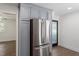 A well-appointed kitchen displays stainless steel refrigerator, gray cabinets and adjacent room views at 1314 Hudson Ave, Durham, NC 27705
