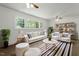 Bright living room with hardwood floors, large windows and comfortable furniture at 1314 Hudson Ave, Durham, NC 27705
