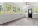 Bright sunroom with many windows providing lots of natural light and featuring hardwood flooring, creating a great living space at 1314 Hudson Ave, Durham, NC 27705