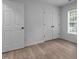 Bright bedroom featuring hard surface flooring, natural light, and closet at 1349 Crabtree Blvd, Raleigh, NC 27610