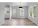 Open dining space with natural light, vinyl flooring and modern pendant lighting at 1349 Crabtree Blvd, Raleigh, NC 27610