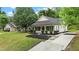 Inviting home featuring a lush green lawn and convenient concrete driveway at 1349 Crabtree Blvd, Raleigh, NC 27610