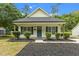 Charming home featuring a welcoming porch and meticulously manicured landscaping at 1349 Crabtree Blvd, Raleigh, NC 27610