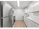 Contemporary kitchen featuring stainless steel appliances and sleek white cabinetry at 1349 Crabtree Blvd, Raleigh, NC 27610