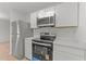 Modern kitchen featuring stainless steel appliances and white cabinets at 1349 Crabtree Blvd, Raleigh, NC 27610