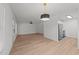 Open-concept living room with hardwood floors, ceiling fan, and stainless steel appliances at 1349 Crabtree Blvd, Raleigh, NC 27610