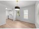 Sun-filled living room with hardwood floors, modern lighting, and stainless steel appliances at 1349 Crabtree Blvd, Raleigh, NC 27610