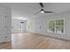 Open living room with vinyl floors, ceiling fan, and plenty of natural light at 1349 Crabtree Blvd, Raleigh, NC 27610