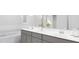 Modern bathroom with double sinks, gray cabinets, and a soaking tub for a spa-like experience at 136 Fairport Ln, Apex, NC 27539