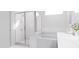 Clean bathroom features a glass-enclosed shower, soaking tub, and modern white fixtures at 136 Fairport Ln, Apex, NC 27539