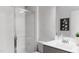 Modern bathroom showcasing a glass-enclosed shower, sleek gray tiles, and a modern sink at 136 Fairport Ln, Apex, NC 27539