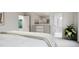 Bright bedroom with a modern dresser, white accents, and an ensuite bathroom entrance for added convenience at 136 Fairport Ln, Apex, NC 27539