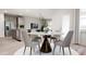 Dining area featuring a round table, modern chairs, and an open view to the kitchen at 136 Fairport Ln, Apex, NC 27539