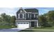 Two-story home with gray siding, a two-car garage, and a well-manicured lawn at 136 Fairport Ln, Apex, NC 27539