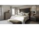 Serene main bedroom with tufted headboard, neutral tones, bedside tables, and elegant decor at 136 Fairport Ln, Apex, NC 27539