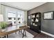 Modern home office with a wooden desk, large window with curtains, and a stylish bookcase at 138 North White St # 200, Wake Forest, NC 27587