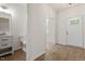 Half bathroom featuring a white vanity, toilet, and modern finishes at 1408 South St, Durham, NC 27707