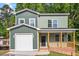 Charming two-story home featuring a covered porch and a single-car garage at 1408 South St, Durham, NC 27707
