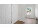 Hallway with wood floors, white walls, and a view of the backyard at 1408 South St, Durham, NC 27707