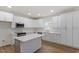 Modern kitchen with white cabinets, quartz countertops, and a kitchen island at 1408 South St, Durham, NC 27707