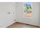 Laundry room with wood floors, white walls, and a window with a view at 1408 South St, Durham, NC 27707