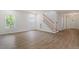 Bright living room with hardwood floors, ample natural light and a staircase to the upper level at 1408 South St, Durham, NC 27707