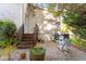 This backyard has a brick surface patio with space for outdoor seating and leads to a charming wooden staircase at 1431 Courtland Dr, Raleigh, NC 27604