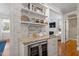 Granite topped bar area with wine fridge and decorative shelving at 1431 Courtland Dr, Raleigh, NC 27604