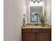 This half bathroom features a granite counter, updated lighting fixtures, and a stylish plant to add character at 1431 Courtland Dr, Raleigh, NC 27604