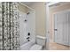 Clean bathroom with white shower, tub, geometric shower curtain, and light-colored walls at 1431 Courtland Dr, Raleigh, NC 27604