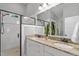 Elegant bathroom with double sinks, granite countertop, walk-in shower, and modern fixtures at 1431 Courtland Dr, Raleigh, NC 27604