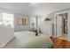 Cozy bedroom with natural light, light green bedding, and a luxurious en suite bathroom at 1431 Courtland Dr, Raleigh, NC 27604