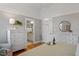 Bright bedroom featuring white trim, hardwood floors, and a view into the bathroom at 1431 Courtland Dr, Raleigh, NC 27604