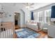 Serene bedroom with daybed, hardwood floor, and adjacent bathroom at 1431 Courtland Dr, Raleigh, NC 27604