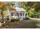 Charming two-story home boasts a welcoming front porch with swing and beautifully landscaped front yard at 1431 Courtland Dr, Raleigh, NC 27604