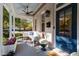 Welcoming front porch with comfortable seating, ceiling fan, and elegant blue door is perfect for relaxation at 1431 Courtland Dr, Raleigh, NC 27604