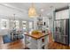 Bright kitchen is open to the dining area, with an island that seats two at 1431 Courtland Dr, Raleigh, NC 27604