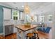 Kitchen with central island offering seating, adjacent to the dining room at 1431 Courtland Dr, Raleigh, NC 27604