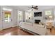 Well-lit living room with hardwood floors, a fireplace, built-in cabinets, and large windows at 1431 Courtland Dr, Raleigh, NC 27604