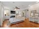 Bright living room featuring hardwood floors, fireplace with built-ins, and large windows with lots of natural light at 1431 Courtland Dr, Raleigh, NC 27604