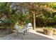 This outdoor patio features a brick surface, a quaint two-chair table, and is surrounded by lush green shrubbery at 1431 Courtland Dr, Raleigh, NC 27604