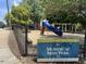View of Mordecai Mini Park sign in front of a playground and surrounding greenery in Raleigh, NC at 1431 Courtland Dr, Raleigh, NC 27604